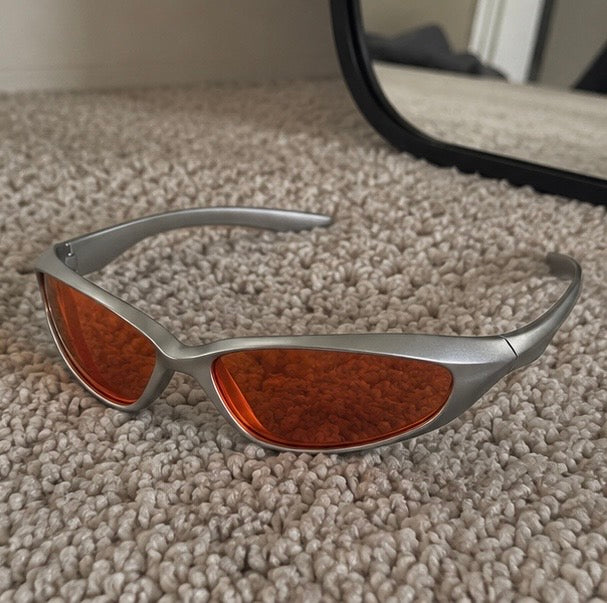 The Flare Sunglasses in silver with amber lens, three-quarter view