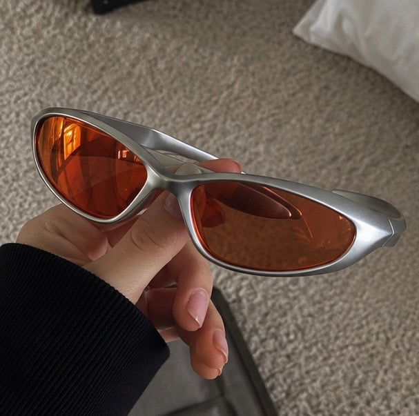 The Flare Sunglasses held in hand, lens detail