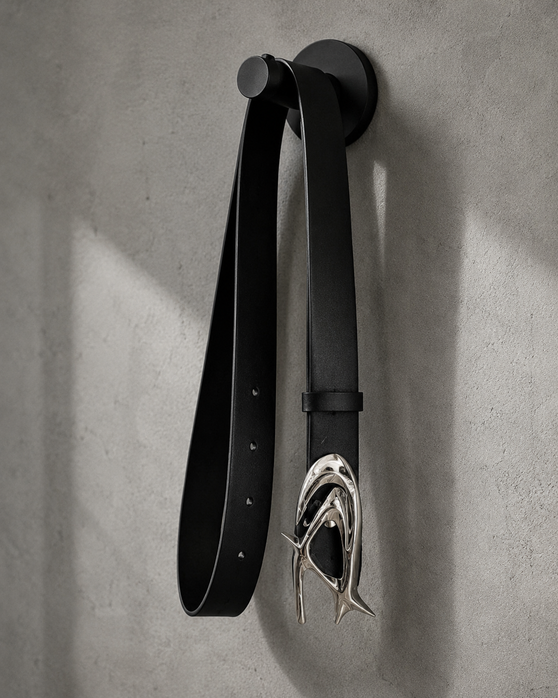 STNDOUT belt hanging on a wall hook